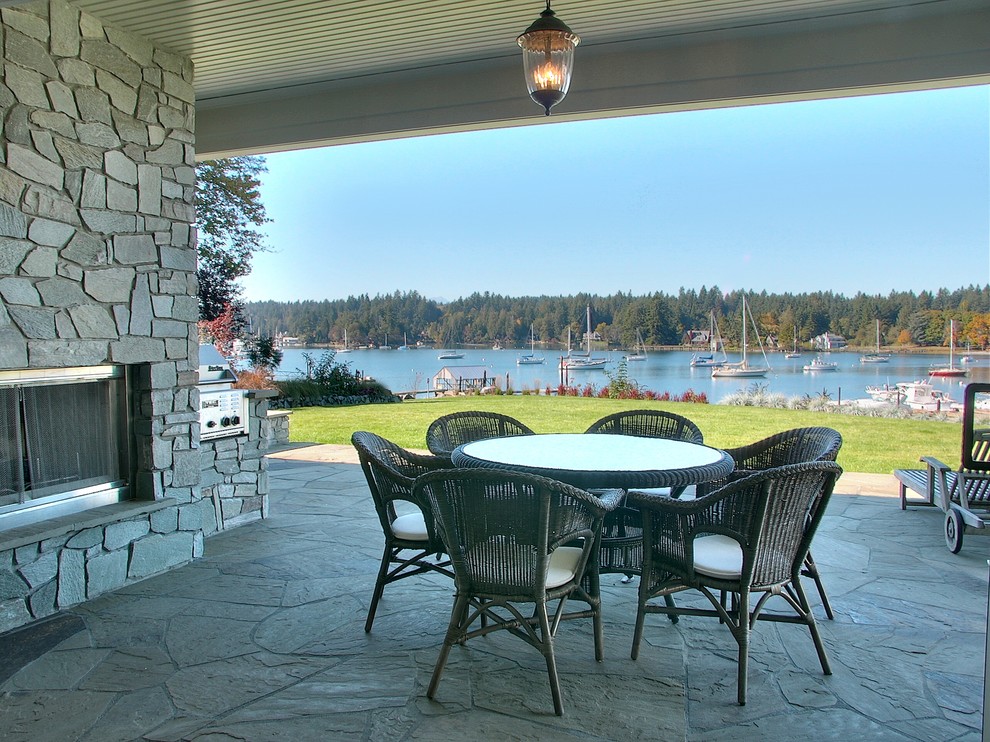 Photo of a classic patio in Seattle with natural stone paving.