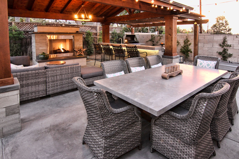 Design ideas for a large traditional back patio in Orange County with an outdoor kitchen, natural stone paving and a gazebo.