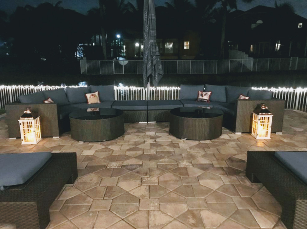 Inspiration for a medium sized modern back patio in Miami with natural stone paving.