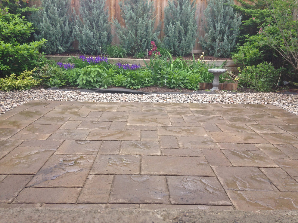 Photo of a small modern back patio in Ottawa with brick paving and no cover.