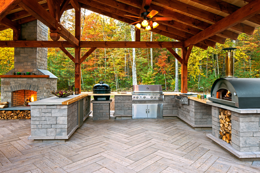 Huge arts and crafts backyard patio kitchen photo in Other with a roof extension and decking