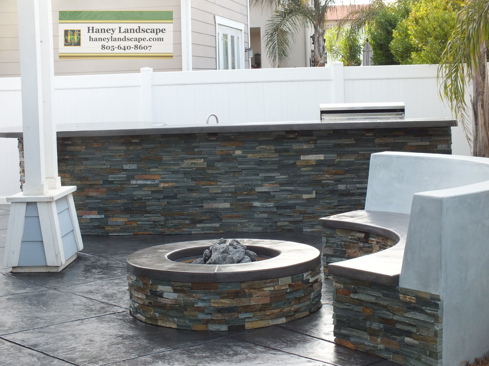 Inspiration for a small contemporary back patio in Santa Barbara with a fire feature and stamped concrete.