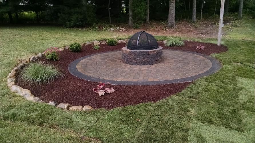 Example of a large transitional backyard concrete paver patio design in Providence with a fire pit and no cover