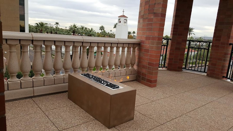Photo of a medium sized mediterranean courtyard patio in Phoenix with a fire feature, concrete paving and a roof extension.
