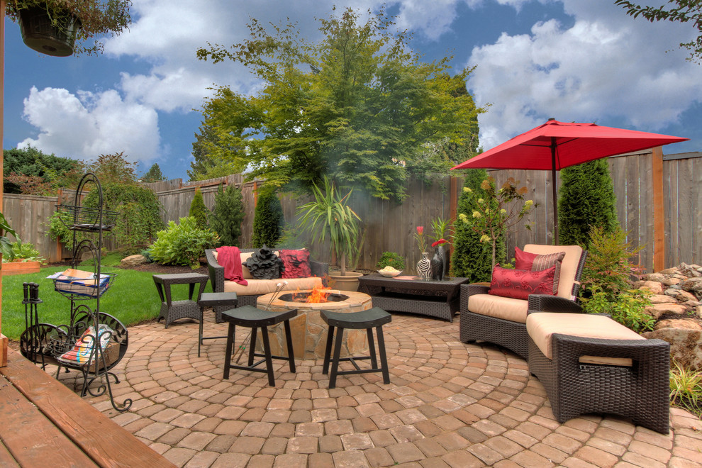 Inspiration for a timeless concrete paver patio remodel in Portland with a fire pit and no cover