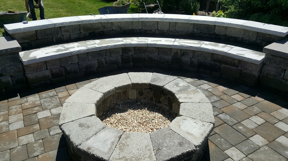 Пример оригинального дизайна: большой двор на заднем дворе в классическом стиле с местом для костра и покрытием из каменной брусчатки без защиты от солнца