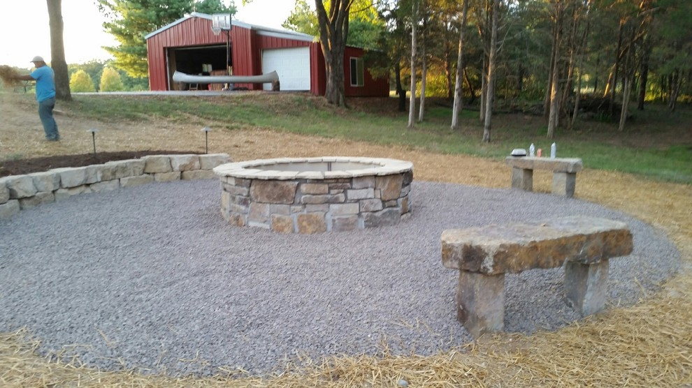 Photo of a medium sized country back patio in St Louis with a fire feature, gravel and no cover.