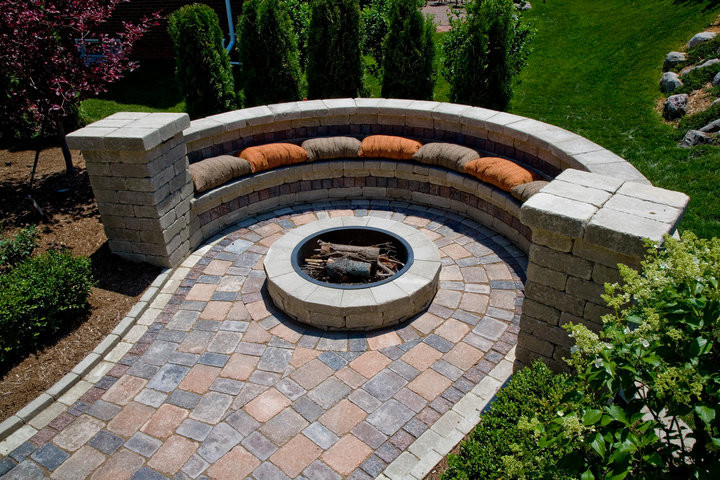Mid-sized elegant backyard concrete paver patio photo in Detroit with a fire pit and no cover