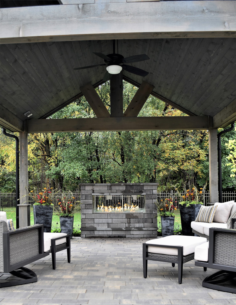 Example of a mid-sized trendy backyard brick patio design in Chicago with a fire pit and a pergola
