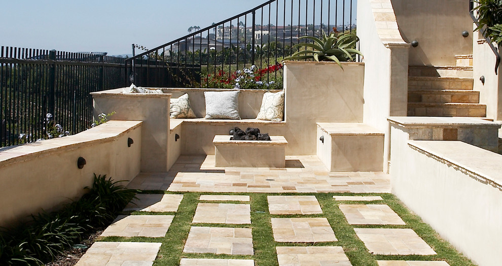Example of a large tuscan backyard stone patio design in New York with a fire pit and no cover