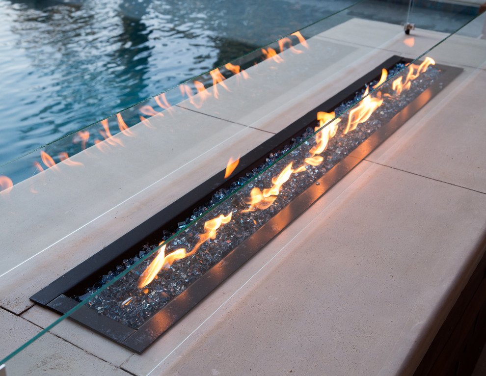 This is an example of a large modern back patio in Atlanta with a fire feature, stamped concrete and a gazebo.