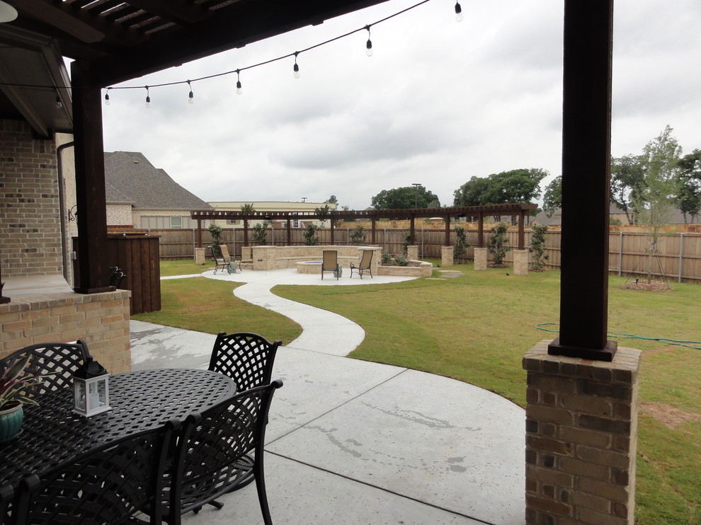 Inspiration for a medium sized traditional back patio in Dallas with an outdoor kitchen, concrete slabs and a pergola.