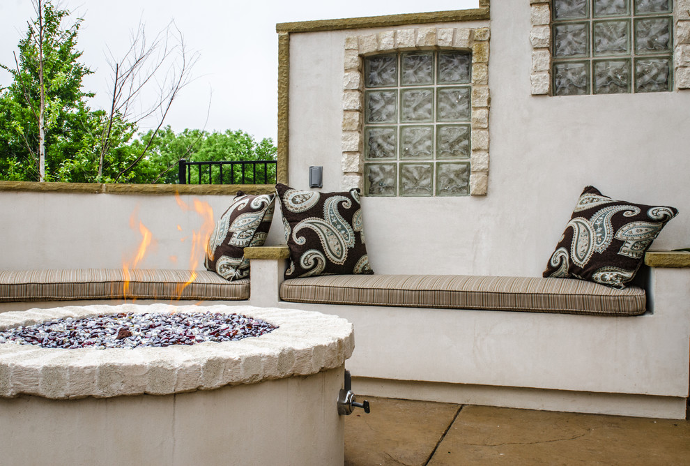 This is an example of a mediterranean patio in Dallas with a fire feature.