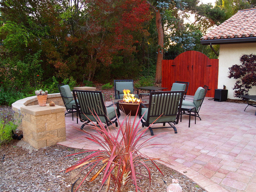 Inspiration for a contemporary back patio in Santa Barbara with a fire feature and concrete paving.