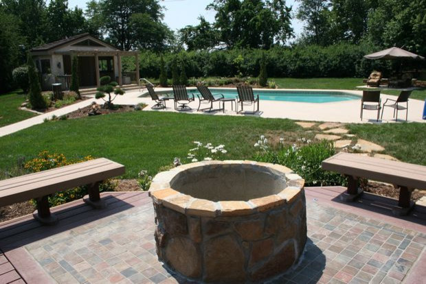 Patio - large traditional backyard concrete paver patio idea in Kansas City with a fire pit and no cover