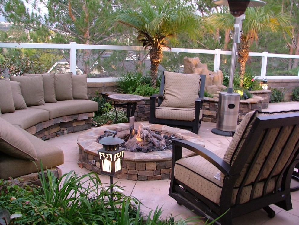 Medium sized traditional back patio in San Diego with a fire feature, concrete slabs and no cover.
