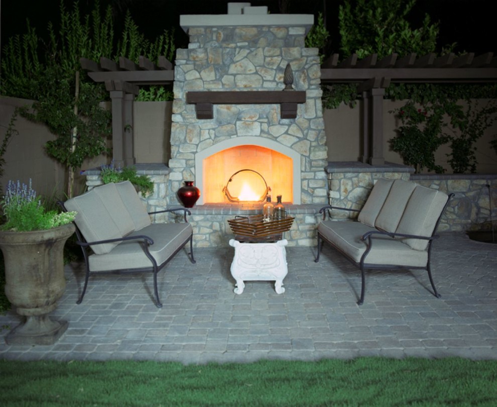 Inspiration for a large southwestern backyard concrete paver patio remodel in Phoenix with a fire pit and a pergola