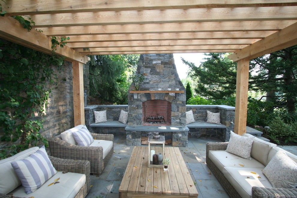 Traditional patio in Philadelphia with a fire feature and a pergola.