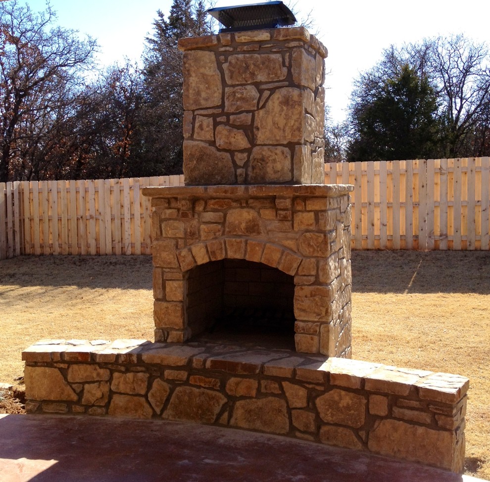 Mid-sized mountain style backyard patio photo in Oklahoma City with a fire pit and no cover