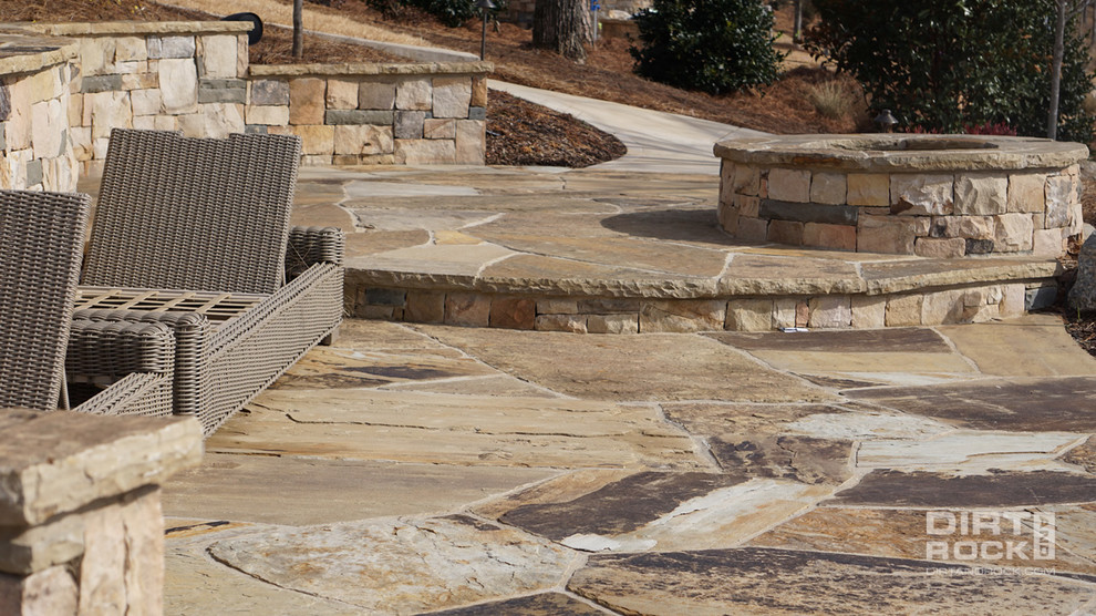 Large traditional back patio in Atlanta with a fire feature, natural stone paving and no cover.