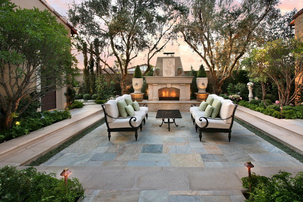 This is an example of a mediterranean patio in Orange County with a fire feature.