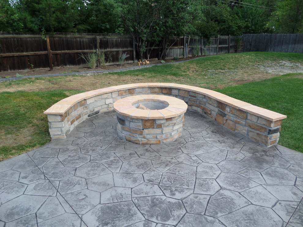 Large elegant backyard stone patio photo in Denver with a fire pit and no cover