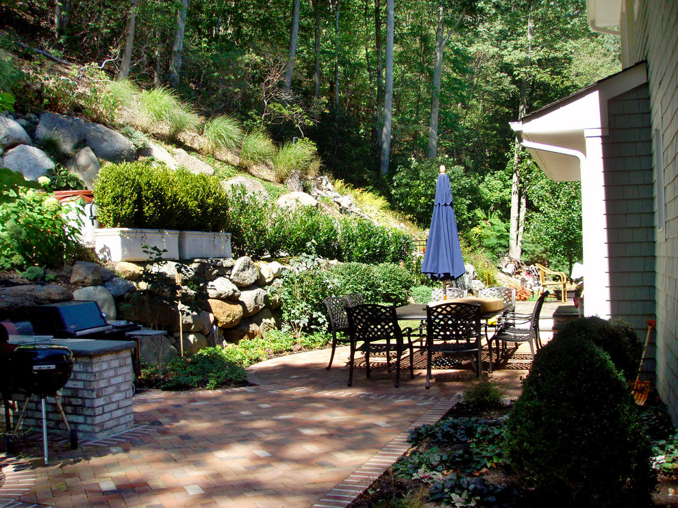 Inspiration for a timeless backyard stone patio kitchen remodel in New York