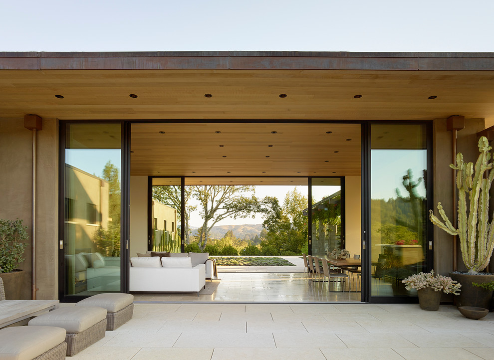 Trendy tile patio photo in Los Angeles with a roof extension