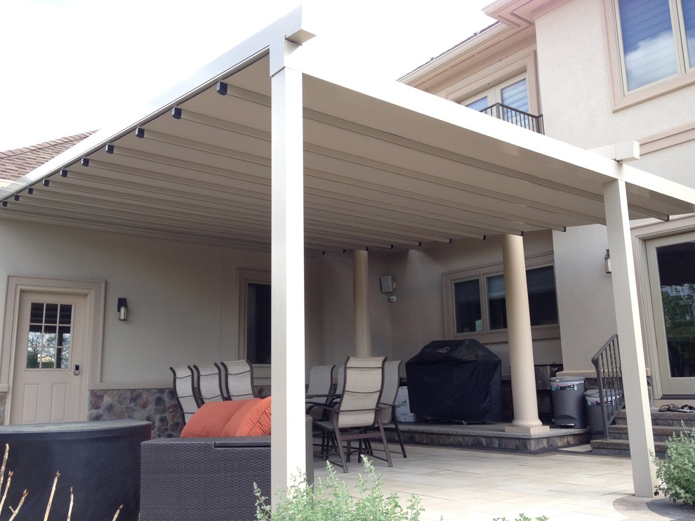 Photo of a medium sized traditional back patio in New York with decking and an awning.