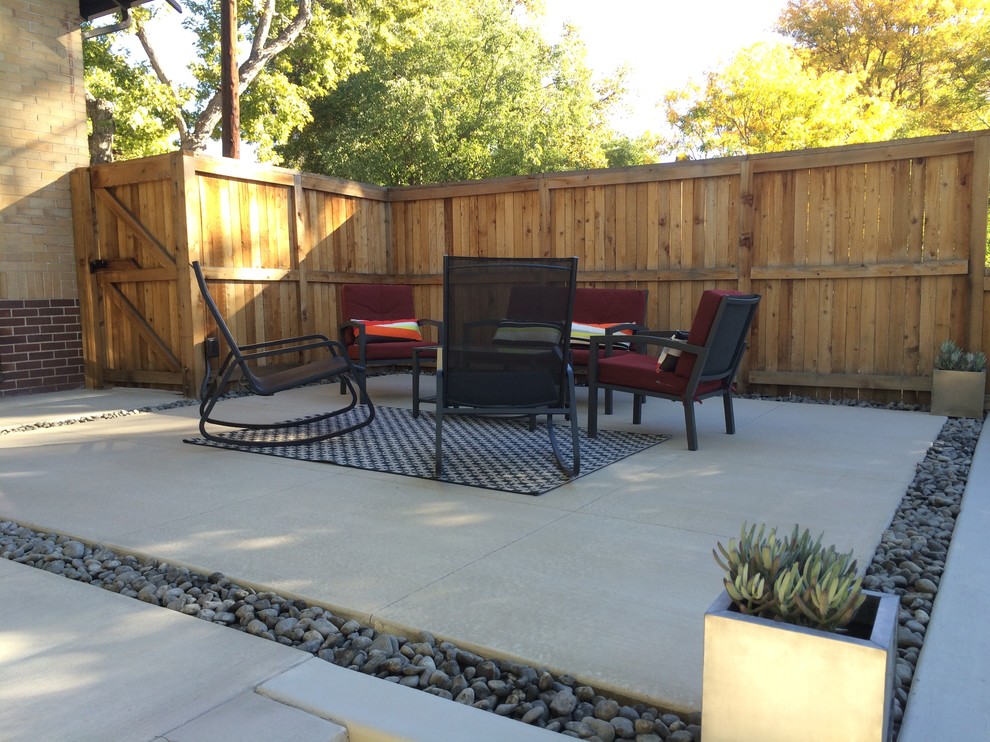 Example of a small minimalist backyard concrete patio design in Denver with no cover
