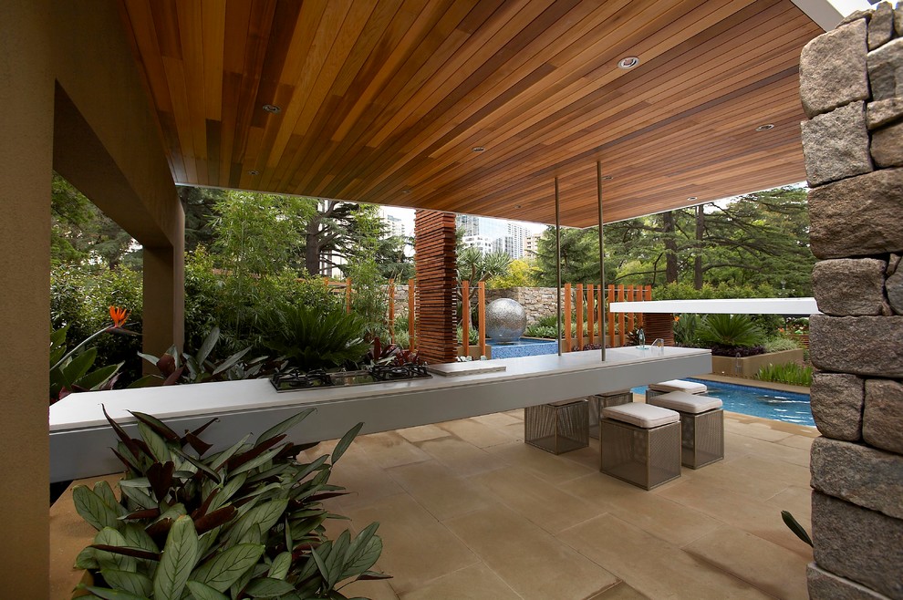 Contemporary back patio in Melbourne with an outdoor kitchen and a pergola.