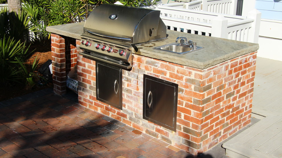 Inspiration for a traditional back patio in Jacksonville with an outdoor kitchen and brick paving.