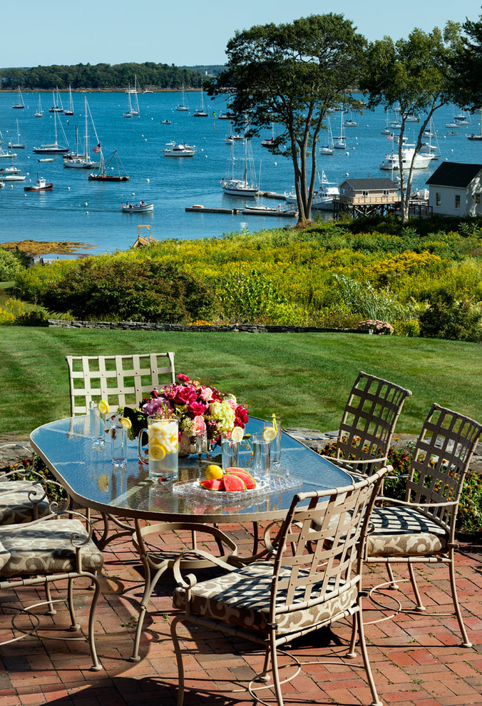 Design ideas for a coastal patio in Portland Maine with brick paving.