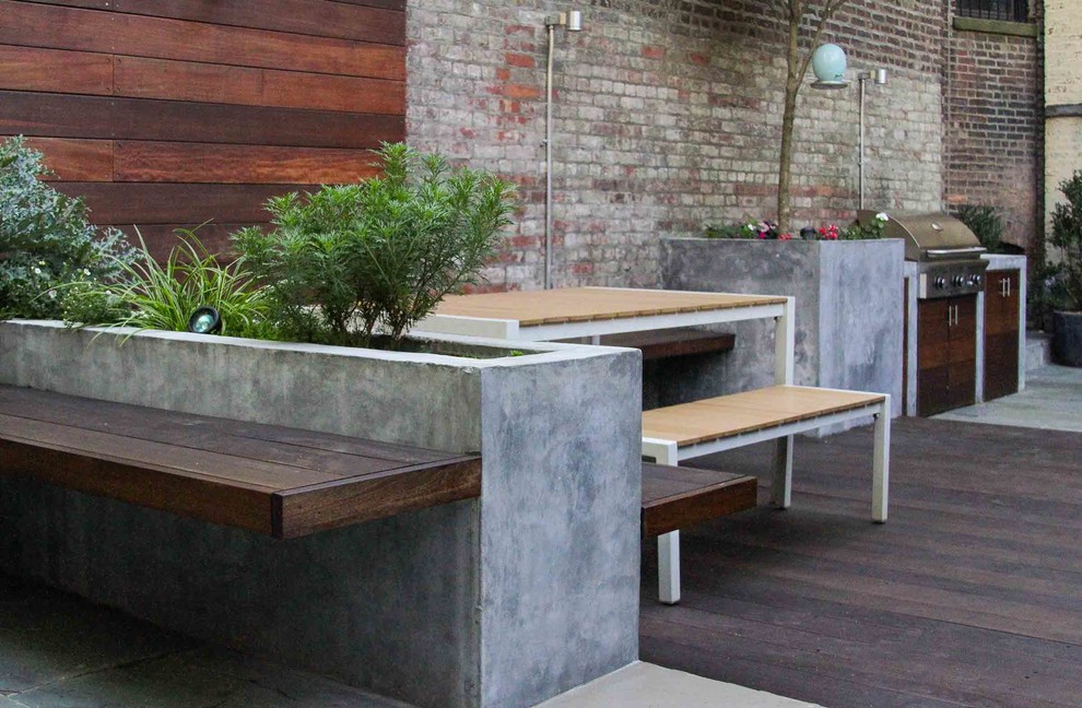 Inspiration for a mid-sized modern backyard stone patio container garden remodel in New York with no cover