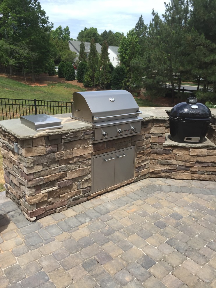 Large classic back patio in Charlotte with an outdoor kitchen.