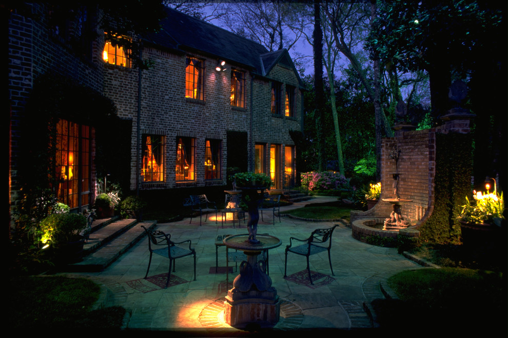 Diseño de patio tradicional grande sin cubierta en patio trasero con adoquines de piedra natural