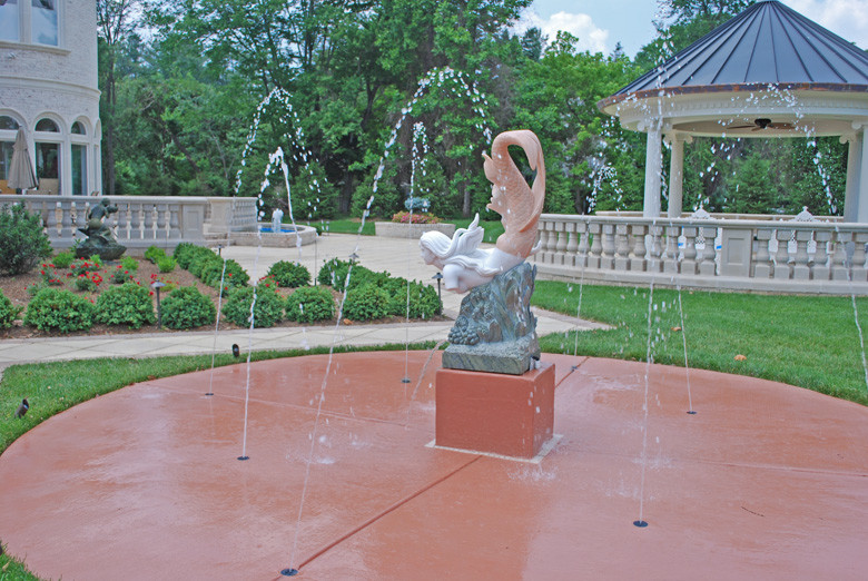 Inspiration for an expansive mediterranean back patio in DC Metro with a water feature and a gazebo.