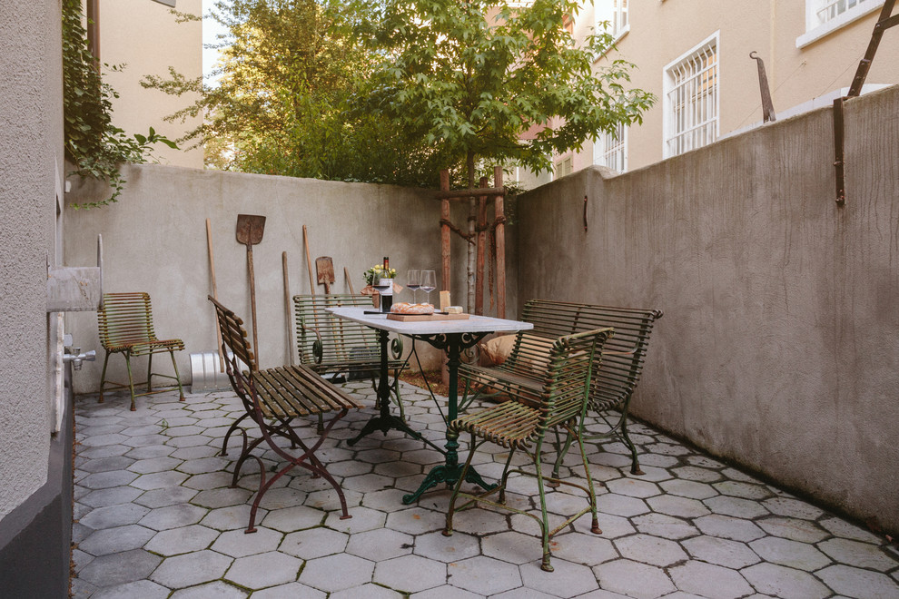 Inspiration for a mid-sized mediterranean backyard concrete paver patio remodel in Other with no cover