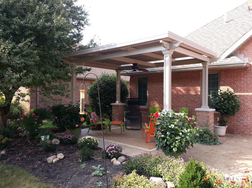 Medium sized bohemian courtyard patio in Other with a gazebo and brick paving.