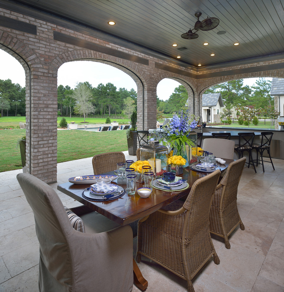 Patio kitchen - huge french country backyard tile patio kitchen idea in Houston with a roof extension