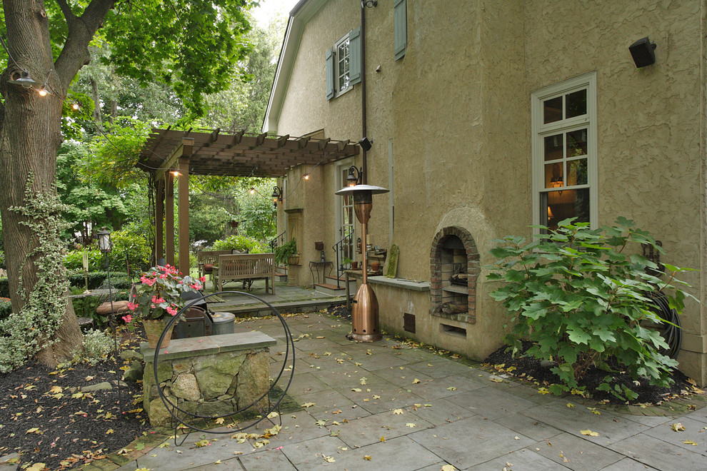 Пример оригинального дизайна: большая пергола во дворе частного дома на заднем дворе в классическом стиле с местом для костра и покрытием из каменной брусчатки