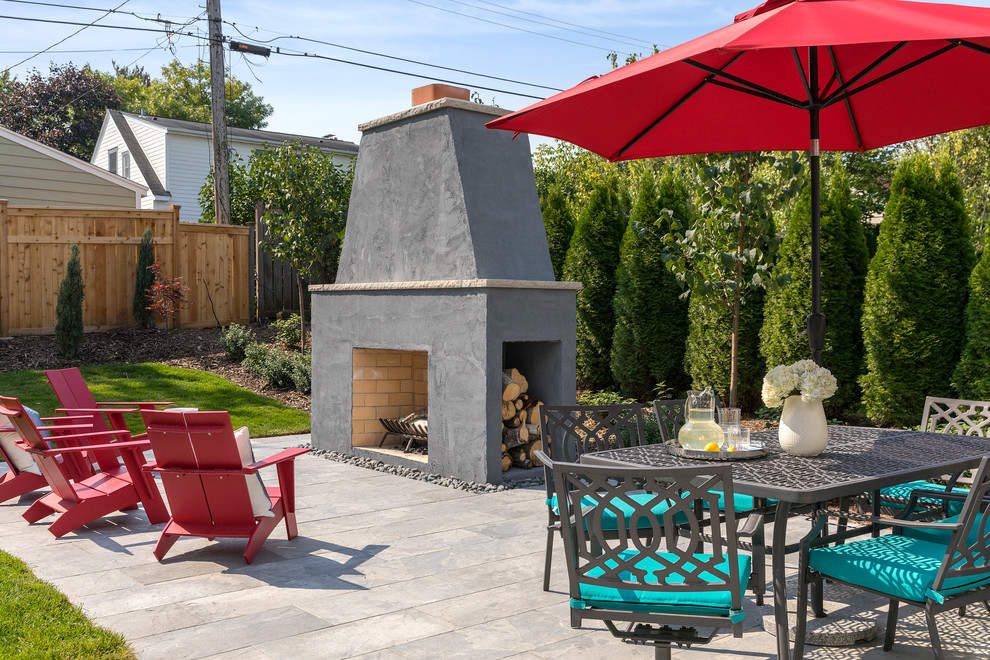 Imagen de patio tradicional renovado sin cubierta en patio trasero con brasero y adoquines de piedra natural