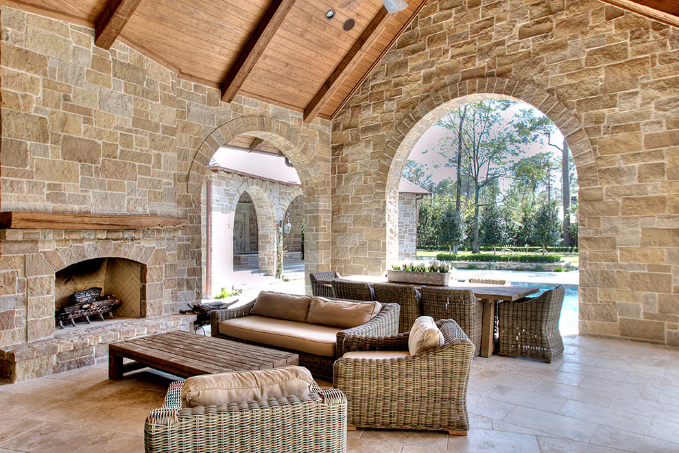 Design ideas for a traditional patio in Houston with a fire feature and a roof extension.