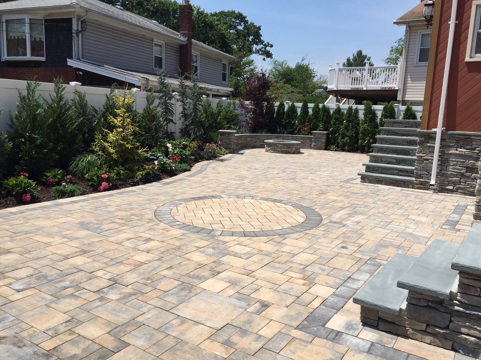 Example of a large classic backyard stone patio design in New York with no cover