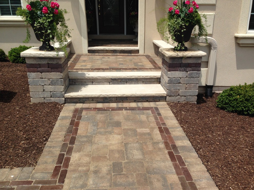 Small elegant front yard concrete paver patio photo in Chicago