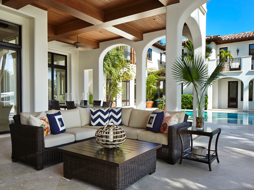 Photo of a mediterranean courtyard patio in Miami with a roof extension.