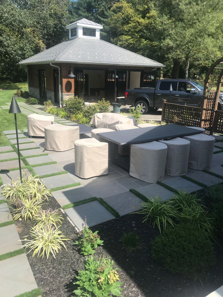 Inspiration for a large contemporary side yard tile patio remodel in New York with a gazebo