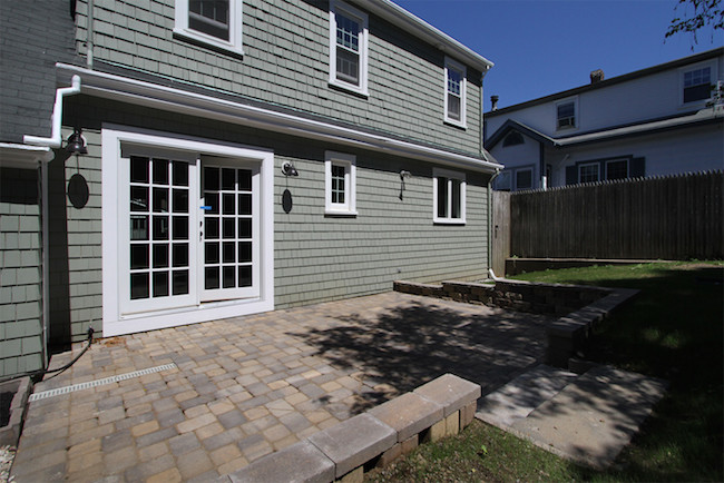 Design ideas for a medium sized modern back patio in Providence with concrete paving and no cover.