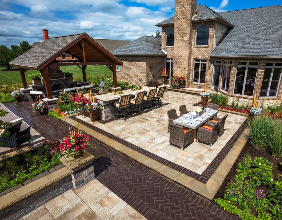 Example of a large trendy backyard brick patio kitchen design in Chicago with a gazebo