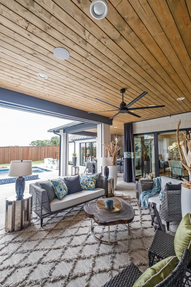 Exemple d'une grande terrasse arrière éclectique avec une cuisine d'été, des pavés en béton et une extension de toiture.